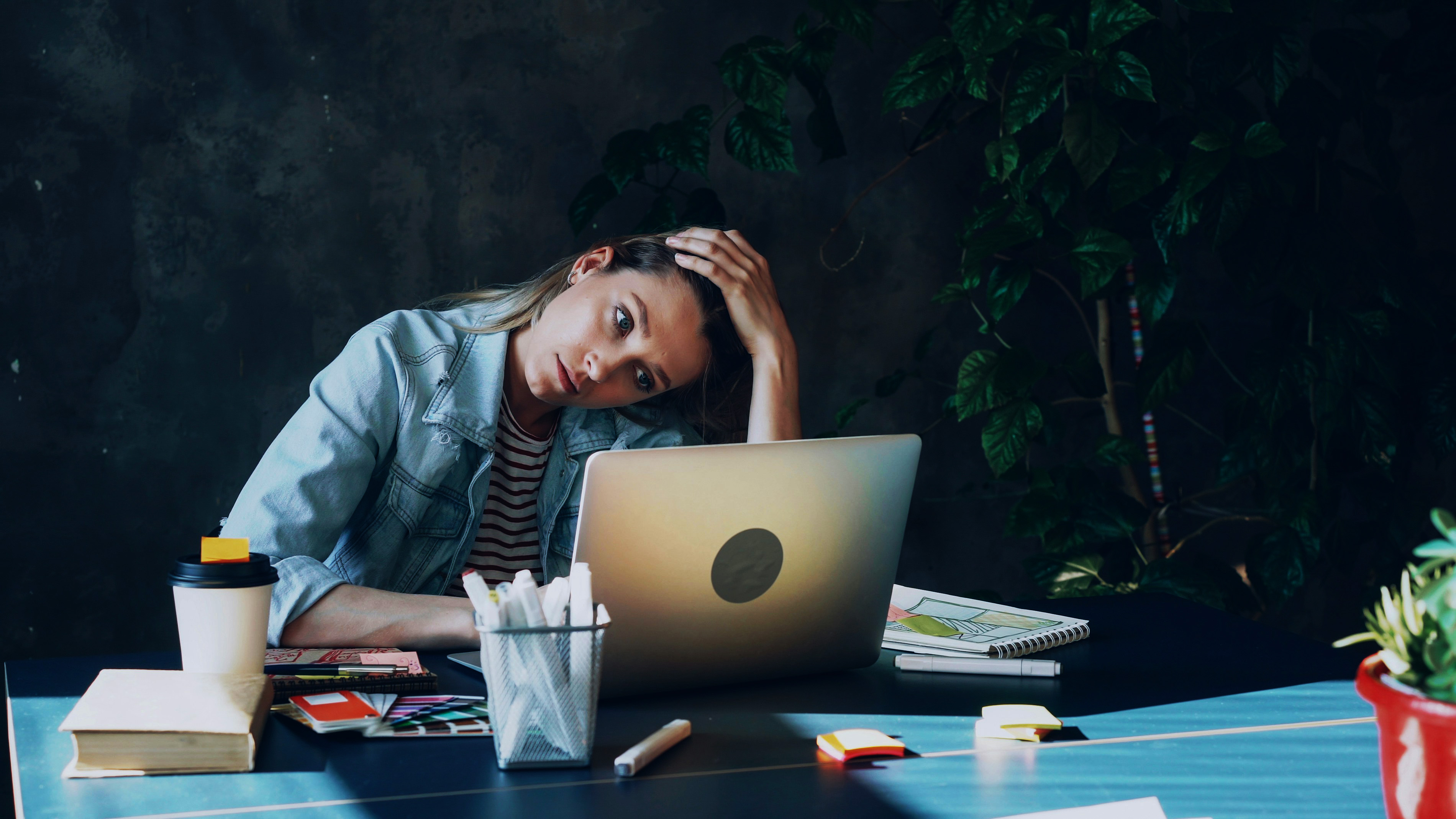 Stressed student working at a laptop